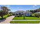 Charming single-story home featuring a well-manicured lawn and elegant landscaping, enhancing its curb appeal at 305 Lake Tahoe Ct, Englewood, FL 34223