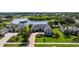 Beautiful single-story home with a well-manicured lawn, lush landscaping, and water views at 305 Lake Tahoe Ct, Englewood, FL 34223