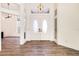 Spacious foyer featuring wood flooring, a decorative light fixture, and an elegant double front door at 305 Lake Tahoe Ct, Englewood, FL 34223
