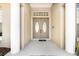 Inviting front entry featuring an elegant double door with oval glass panels and classic column accents at 305 Lake Tahoe Ct, Englewood, FL 34223