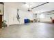Spacious garage interior with ample room for parking and storage, featuring a ceiling fan at 305 Lake Tahoe Ct, Englewood, FL 34223
