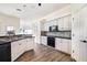 Clean kitchen features white cabinetry, stainless appliances, and stylish black countertops at 305 Lake Tahoe Ct, Englewood, FL 34223