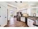 Bright kitchen showcases an open layout, stainless steel refrigerator, and wood flooring at 305 Lake Tahoe Ct, Englewood, FL 34223