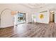 Bright living room with wood floors, tray ceilings, and large sliding doors with a pool view at 305 Lake Tahoe Ct, Englewood, FL 34223