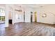 Open-concept living room with wood floors, tall ceilings, and plenty of natural light from the front doors and windows at 305 Lake Tahoe Ct, Englewood, FL 34223