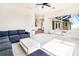Bright living room with sectional sofa opens to the pool area through sliding glass doors at 305 Lake Tahoe Ct, Englewood, FL 34223