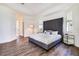 Main bedroom boasting a large bed, tray ceiling, and hardwood floors at 305 Lake Tahoe Ct, Englewood, FL 34223