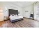 Spacious main bedroom with a high headboard, tray ceiling and hardwood floors at 305 Lake Tahoe Ct, Englewood, FL 34223