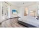 Main bedroom with hardwood floors, tray ceilings and balcony access at 305 Lake Tahoe Ct, Englewood, FL 34223
