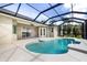 Inviting screened-in pool with bright blue water, and covered patio at 305 Lake Tahoe Ct, Englewood, FL 34223