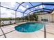 Relaxing screened-in pool area with a lake view at 305 Lake Tahoe Ct, Englewood, FL 34223