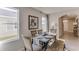 Bright dining room with farmhouse style table, bench seating, large windows, and stylish decor at 30823 Wild Juniper Ct, Brooksville, FL 34602