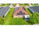 Aerial view of a single-Gathering home with solar panels, green lawn, and screened-in patio at 6812 Gideon Cir, Zephyrhills, FL 33541