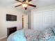Bedroom with carpet, a bed and pillows, TV, closet and a window with natural light for a relaxing atmosphere at 6812 Gideon Cir, Zephyrhills, FL 33541