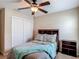 Bedroom with soft lighting, carpet, a queen-sized bed with pillows and a window with natural light plus a closet at 6812 Gideon Cir, Zephyrhills, FL 33541