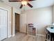 Bedroom with light-colored walls, a ceiling fan, a closet, and an adjacent doorway plus light wood flooring at 6812 Gideon Cir, Zephyrhills, FL 33541