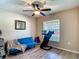 Bedroom featuring a window, ceiling fan, closet and light wood flooring with a blue futon and exercise equipment at 6812 Gideon Cir, Zephyrhills, FL 33541
