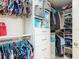 Organized walk-in closet with custom shelving, drawers, and ample storage space for clothing and accessories at 6812 Gideon Cir, Zephyrhills, FL 33541