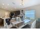 Bright dining area adjoining the kitchen, featuring a modern table, chairs, and natural light at 6812 Gideon Cir, Zephyrhills, FL 33541