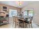 Cozy dining area featuring a stylish table, comfortable chairs, and view to the exterior patio at 6812 Gideon Cir, Zephyrhills, FL 33541