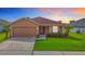 Charming single-Gathering home with a well-manicured lawn and an attached two-car garage at 6812 Gideon Cir, Zephyrhills, FL 33541