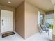 Welcoming front porch with seating area and a well-maintained exterior at 6812 Gideon Cir, Zephyrhills, FL 33541