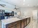 Spacious kitchen island with stainless steel sink, granite countertops and hardwood cabinetry at 6812 Gideon Cir, Zephyrhills, FL 33541