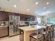 Lovely eat-in kitchen with stainless steel appliances, granite counters, hardwood cabinetry, and a stylish island at 6812 Gideon Cir, Zephyrhills, FL 33541