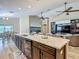 Open concept living and dining area with a kitchen island, stainless steel appliances, and hardwood cabinetry at 6812 Gideon Cir, Zephyrhills, FL 33541
