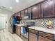 Elegant kitchen featuring modern appliances, wooden cabinets, and stylish backsplash at 6812 Gideon Cir, Zephyrhills, FL 33541