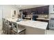 Bright, open kitchen with a large island, stylish countertops, wooden cabinets, and seating at 6812 Gideon Cir, Zephyrhills, FL 33541
