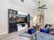 Inviting living room with a stylish entertainment center, comfortable seating, and a ceiling fan at 6812 Gideon Cir, Zephyrhills, FL 33541