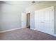 Neutral toned bedroom showcasing double door closet, plush carpet and ensuite at 3018 Oceanside St, North Port, FL 34286