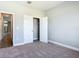 Bright bedroom with carpet flooring and a closet with white doors offers ample storage space at 3018 Oceanside St, North Port, FL 34286