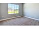 Bedroom with carpet, base trim and a large window, ready for furnishings at 3018 Oceanside St, North Port, FL 34286