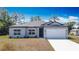 Charming single-story home with a well-maintained lawn and a two-car garage at 3018 Oceanside St, North Port, FL 34286