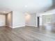 Open-concept living room features wood-look floors and a convenient sliding barn door at 3018 Oceanside St, North Port, FL 34286