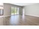 Bright living area boasts wood-look floors, a large sliding glass door, and neutral walls at 3018 Oceanside St, North Port, FL 34286
