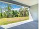 Covered patio offers scenic views of the lush greenery and mature trees in the backyard at 3018 Oceanside St, North Port, FL 34286