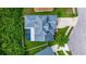 Bird's eye view of a home featuring a backyard with a screened pool and an expansive roofline in a suburban setting at 205 Bengal Cir, Oldsmar, FL 34677