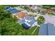 Beautiful aerial view showcasing a home with a screened pool and well-maintained landscaping in a residential neighborhood at 205 Bengal Cir, Oldsmar, FL 34677