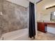 Bathroom with a tiled shower and a vanity featuring cherry-wood cabinets and granite countertops at 205 Bengal Cir, Oldsmar, FL 34677