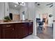 Bathroom vanity with granite countertops and views into the living area and office space at 205 Bengal Cir, Oldsmar, FL 34677