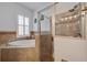 Bathroom features a soaking tub, walk-in shower with glass door, and tile surround at 205 Bengal Cir, Oldsmar, FL 34677