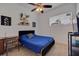 Comfortable bedroom with a ceiling fan, bright natural light, stylish decor, and a cozy blue bed at 205 Bengal Cir, Oldsmar, FL 34677