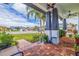 Inviting front porch with brick flooring, decorative columns, and lush landscaping overlooking the charming neighborhood street at 205 Bengal Cir, Oldsmar, FL 34677