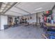 Spacious garage with finished floor, overhead lighting, storage shelves, and home gym at 205 Bengal Cir, Oldsmar, FL 34677