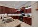 Kitchen boasts granite countertops, black appliances, and ample cabinetry at 205 Bengal Cir, Oldsmar, FL 34677