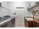 Laundry room with washer, dryer, utility sink, and storage shelves at 205 Bengal Cir, Oldsmar, FL 34677