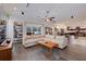 Inviting living room boasts a large sectional sofa, modern shelving, and an open floor plan to the kitchen at 205 Bengal Cir, Oldsmar, FL 34677